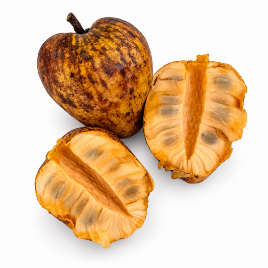 Pond apple, whole and cut open to show the flesh, on a white background