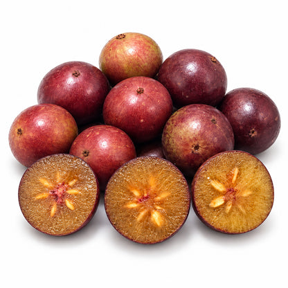 Indian Plum / Coffee Plum cut open to show the flesh on a white background